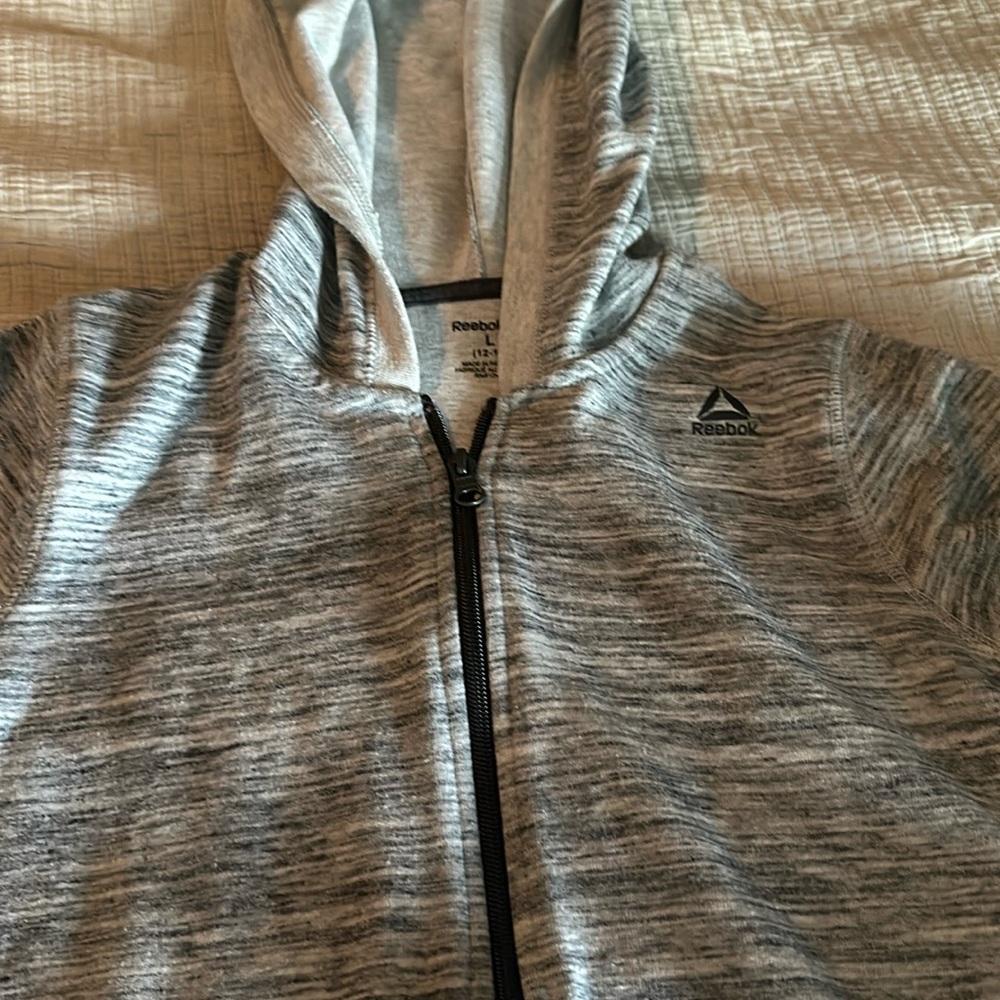 Reebok zip up hoodie.  Grey with front pockets size girls large 12-14